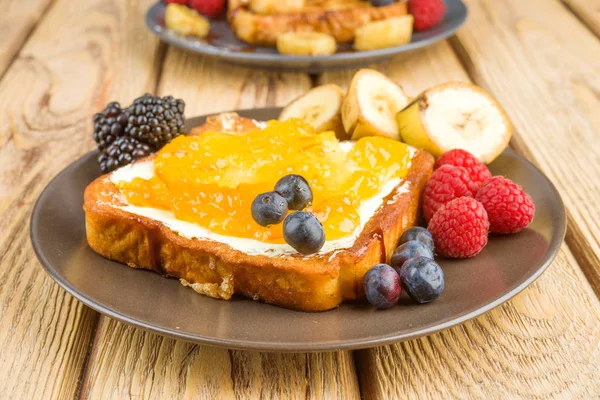 french toast with butter and marmalade on wood