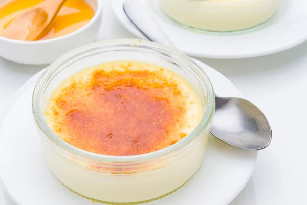 homemade creme brulee with burnt sugar, isolated on white