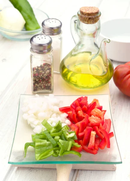 chopped vegetables and oil on wooden