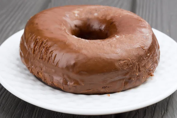 chocolate donut on  black wooden  base