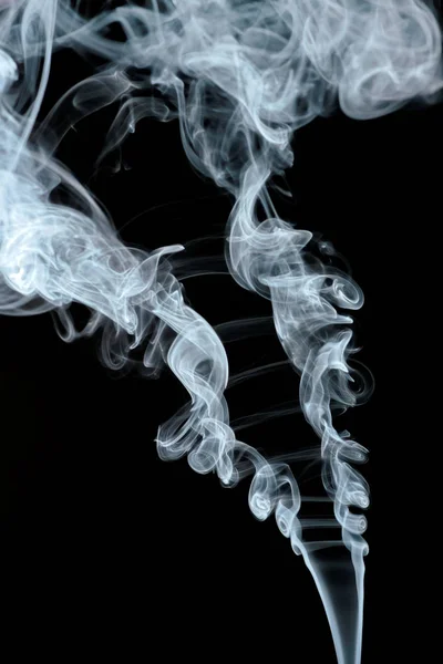 abstract shapes formed by scrolls of incense smoke