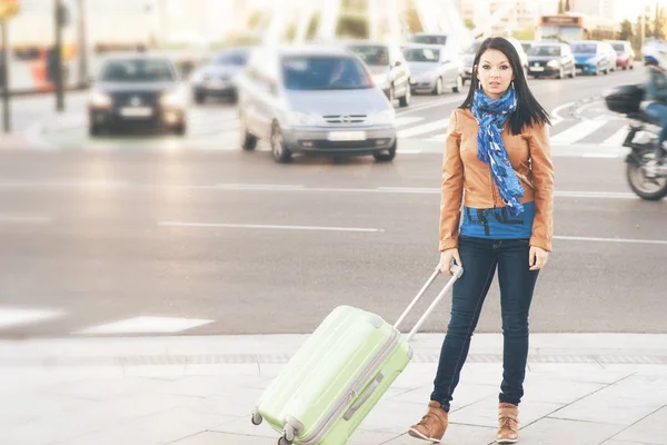 Young woman travels through the city on a cold day