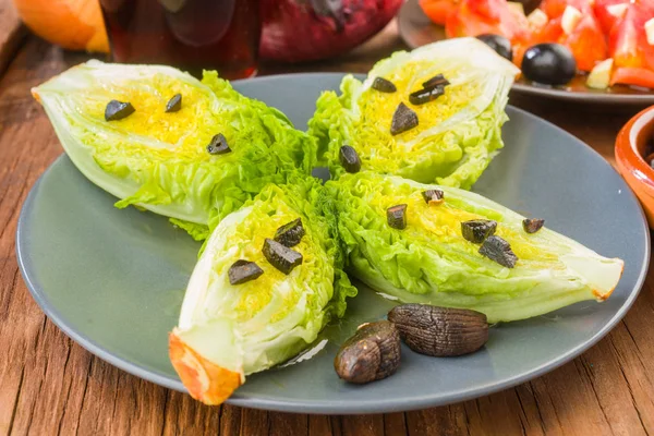 lettuce hearts with olive oil and black garlic