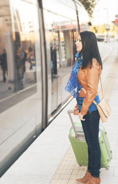 Young woman travels through the city on a cold day