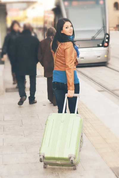 Young woman travels through the city on a cold day