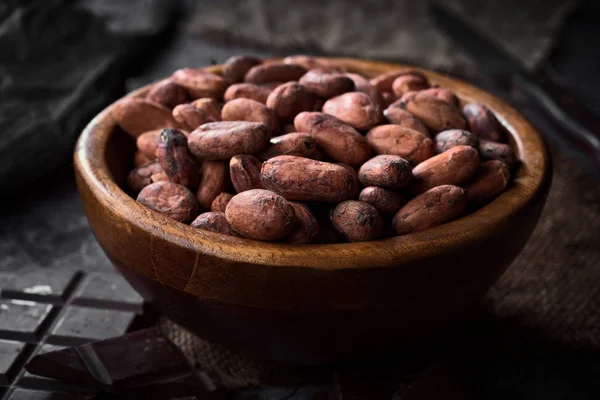 wooden bowl filled with cocoa seeds