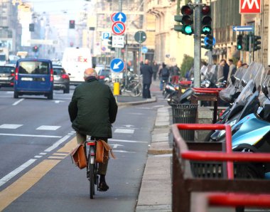 Milano, 19 Ekim 2017: Şehir trafiğinde bisiklet yolunda bisikletçiyi çağrıştıran bir hayal