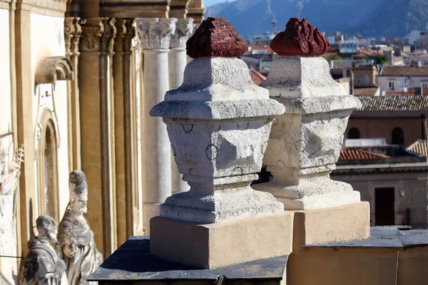 Palermo, Italy - evocative foreground image of concrete planters with statues of the facade of the church of San Domenico in the background