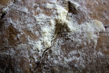 Un, reçine unu, maya, su, yağ ve tuzdan oluşan mavi ve beyaz çizgili bir çay havlusunun içinde yoğurup bıraktıktan sonra ev yapımı ekmeğin yakın plan çekimi.