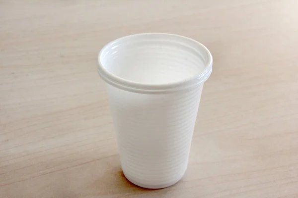white plastic cup on background