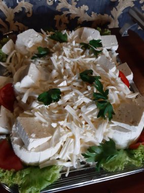 Masada çeşitli peynirlerle servis edilen peynir tabağı.