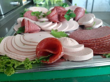 Servis tabağında dilimlenmiş salam çeşitleri