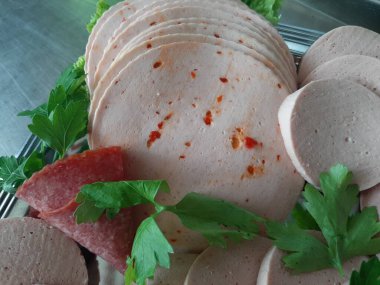 Servis tabağında dilimlenmiş salam çeşitleri