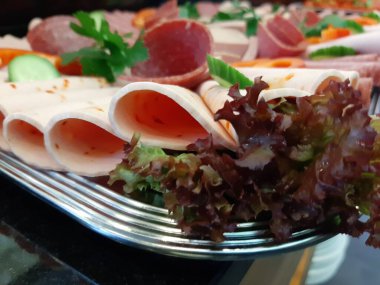 Servis tabağında dilimlenmiş salam çeşitleri