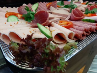 Servis tabağında dilimlenmiş salam çeşitleri