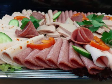 Servis tabağında dilimlenmiş salam çeşitleri