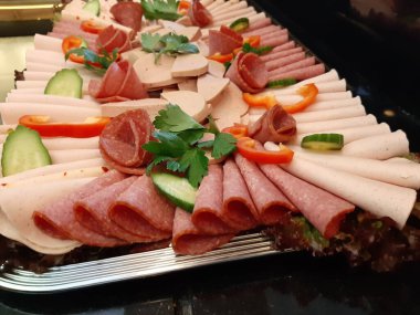 Servis tabağında dilimlenmiş salam çeşitleri