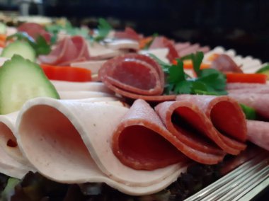 Servis tabağında dilimlenmiş salam çeşitleri