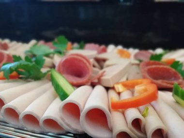 Servis tabağında dilimlenmiş salam çeşitleri