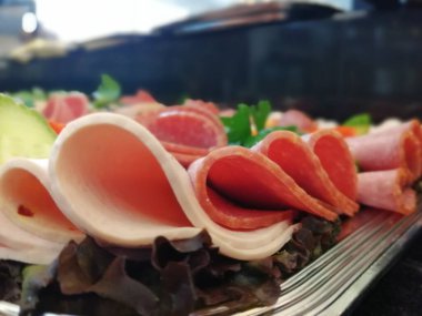 Servis tabağında dilimlenmiş salam çeşitleri