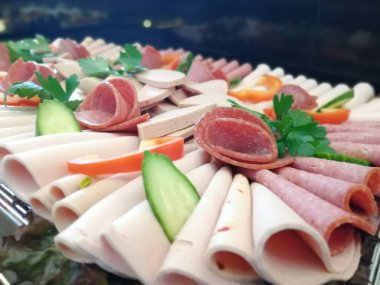 Servis tabağında dilimlenmiş salam çeşitleri