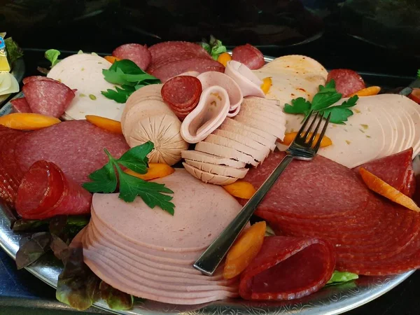 sliced salami varieties on serving plate
