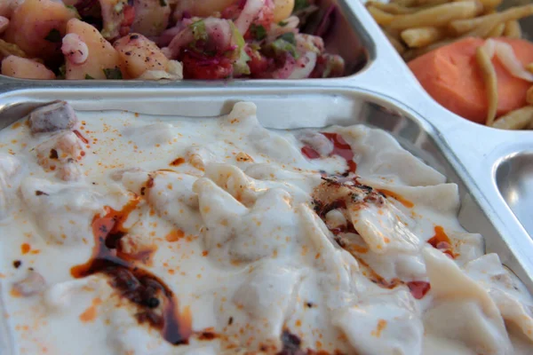 Servis tabağında lezzetli tereyağlı Türk mantısı.