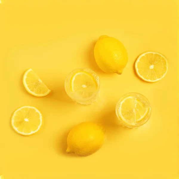 Citrus lemonade. Detox with lemon on a yellow background.