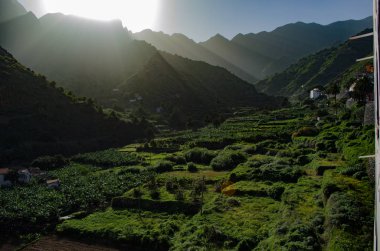 The valley of Hermigua during the sunrise in La Gomera Island. El Valle de Hermigua, La Gomera, Canary islands, Spain. Morning haze in Hermigua valley, La Gomera. clipart