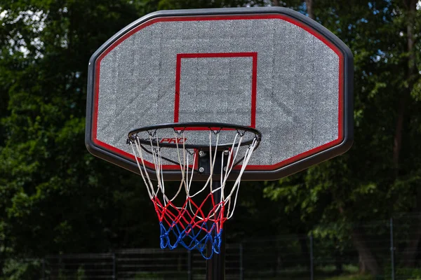 Close-up of a basketball basket in a city park.