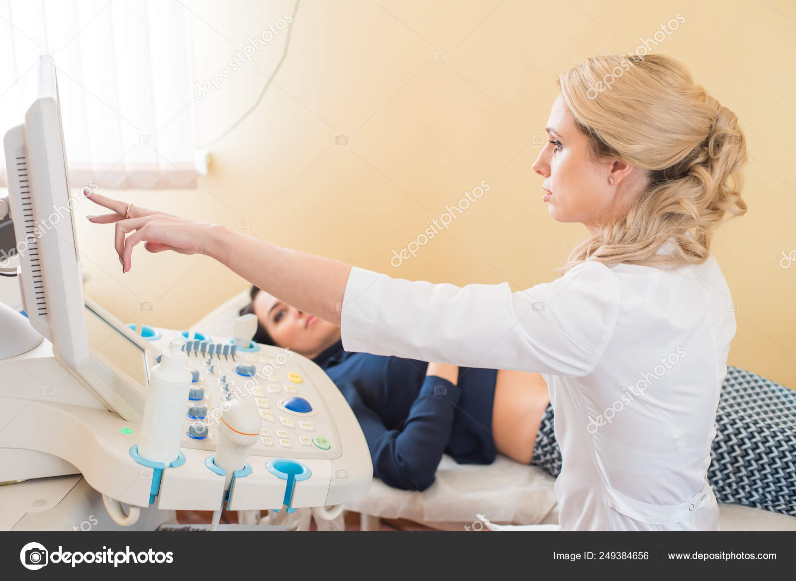 Ultrasound test. Pregnancy. Gynecologist checking fetal life with scanner. Exam. Stock Photo by
