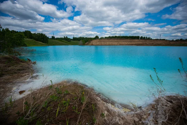 Alkaline solution. Ash dump dumping waste into the water. Ecological catastrophy. Turquoise dead water is like an oasis. The result of the waste plant in an artificial reservoir.