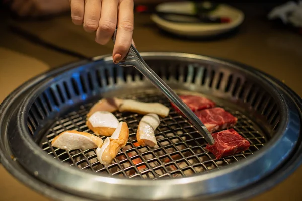 Świeżego mięsa. Grillowania mięsa w koreańskiej restauracji. Tradycyjne dania kuchni koreańskiej. — Zdjęcie stockowe