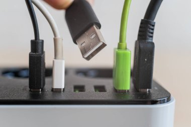 Cihazlar için modern çoklu port usb şarj cihazı. Elektrik prizine yerleştirilmiş çok renkli kabloların yakın plan görüntüsü. Makro.