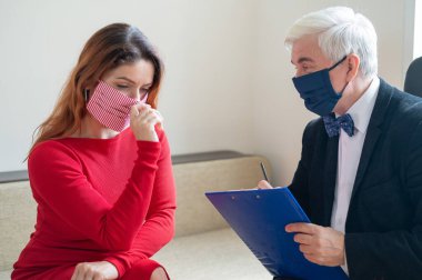 Erkek psikoterapist, maskeli bir kadın müşteriye tavsiye eder. Koronavirüs salgını sırasında manevi destek. Depresyondaki kadın psikoloğa gitti. Hastalık ve panik atak tedavisi