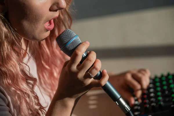 Nahaufnahme einer Frau, die in ein Mikrofon singt. — Stockfoto