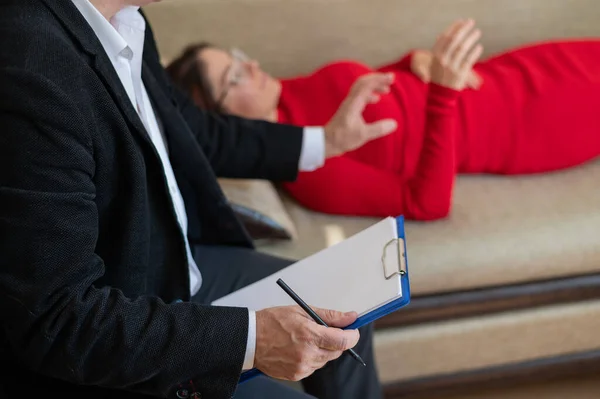 Eine Frau liegt während einer Psychotherapie-Sitzung auf einer Couch — Stockfoto