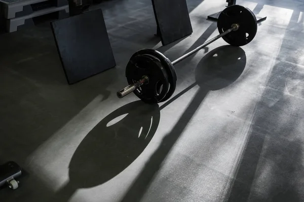 Barbell on the floor in the gym — Stock Photo, Image