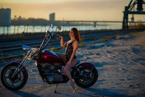 Mujer pelirroja en lencería sexy en tacones altos se sienta en una motocicleta —  Fotos de Stock