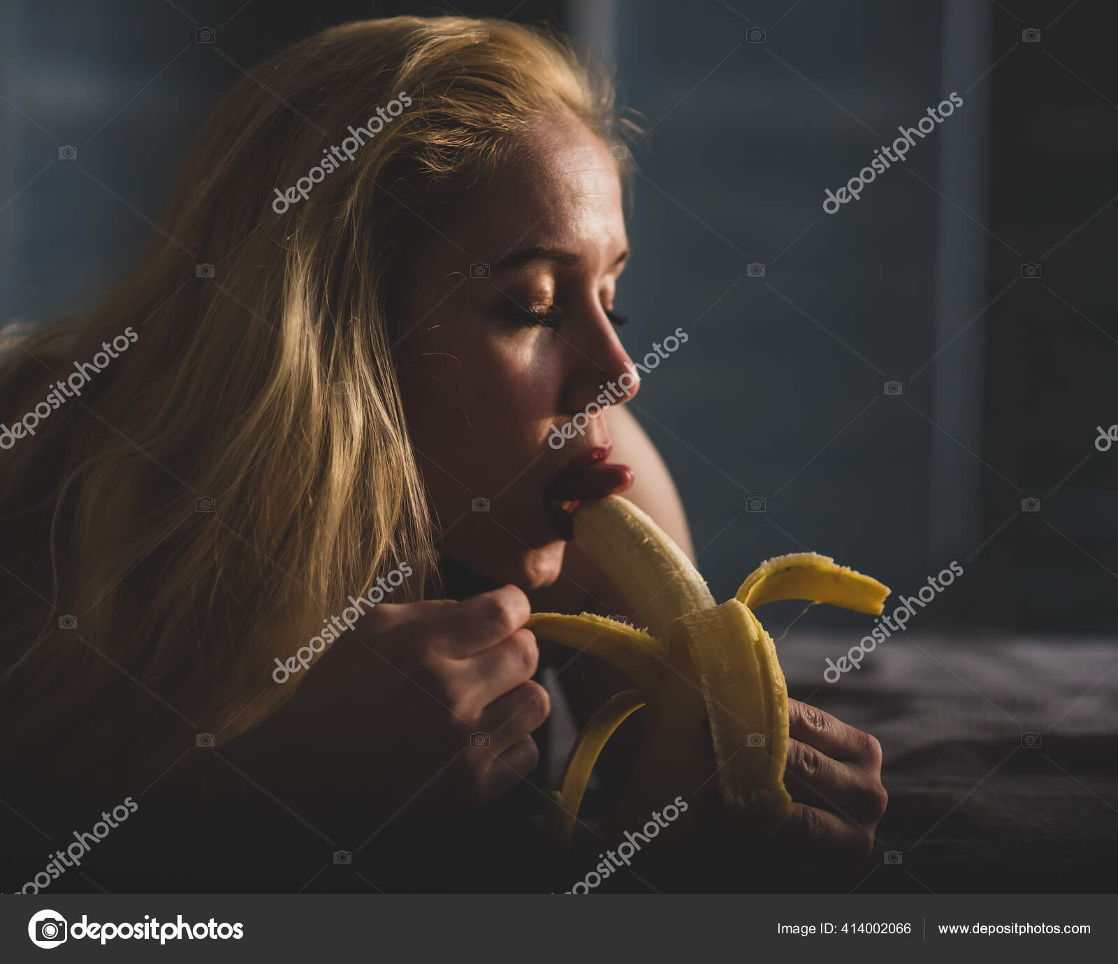 The blonde imitates oral sex and sucks a banana Stock Photo by ©inside-studio 414002066