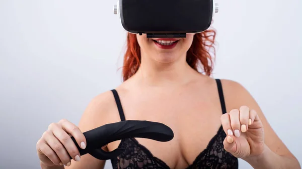 Woman in VR glasses with a black dildo on a white background. The girl masturbates and watches 3d porn — Foto de Stock