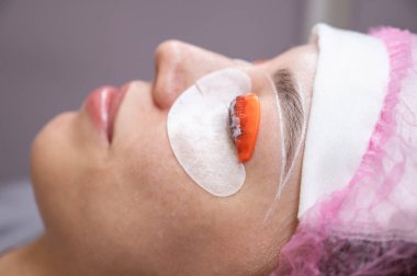 Beyaz kadın kirpik temizleme prosedüründen geçiyor.