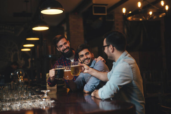 The guys in the pub are drinking beer