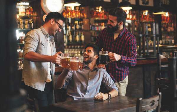 The guys in the pub are drinking beer