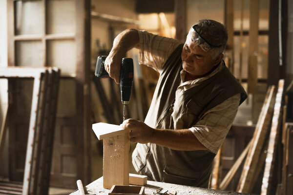 Carpenters at work in his workshop