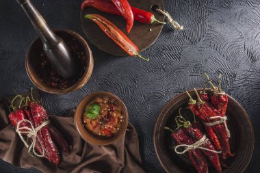 Seramik tabaklarda koyu bir arka plan üzerinde baharatlı biber, flatlay.