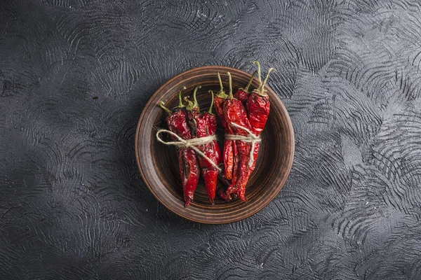 Seramik tabaklarda koyu bir arka plan üzerinde baharatlı biber, flatlay.