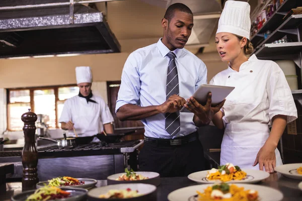 Male Manager Female Chef Using Digital Tablet Kitchen Hotel — Stock Photo, Image