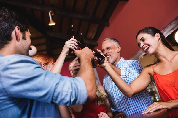 Low Angle View Friends Toasting Beer Bottle Nightclub — Stock Photo, Image