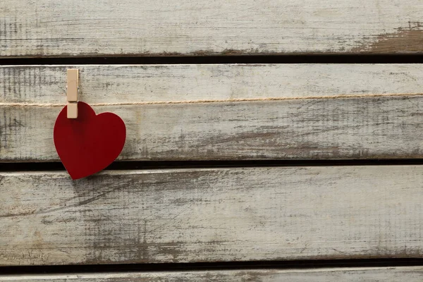 Καρδιά Σχήμα Διακόσμηση Κρέμεται Από Νήμα Εναντίον Ξύλινη Σανίδα — Φωτογραφία Αρχείου